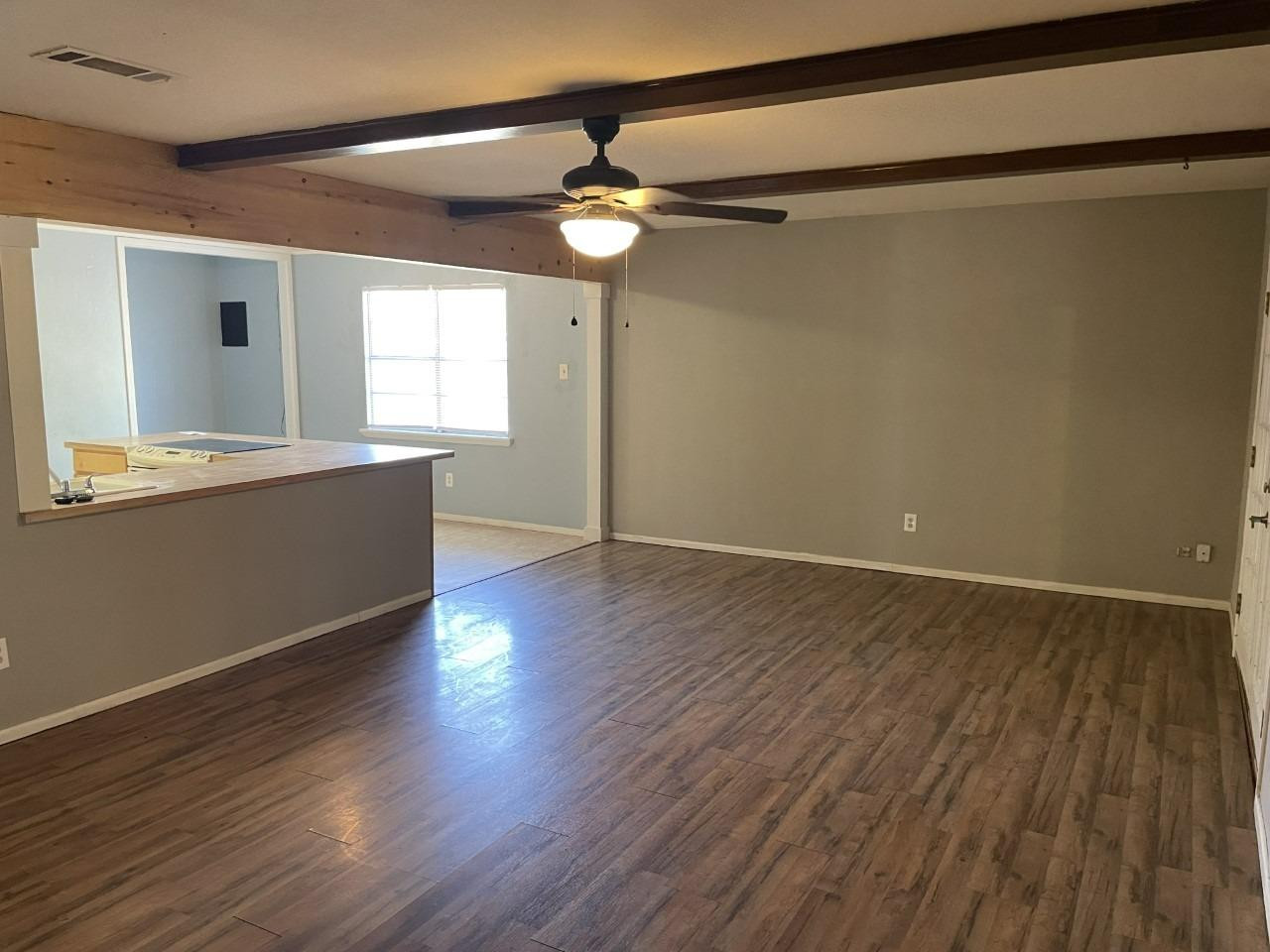 4832 9th Street Lubbock, TX 79416 - Photo 3 of 10 a view of a livingroom with wooden floor and a ceiling fan
