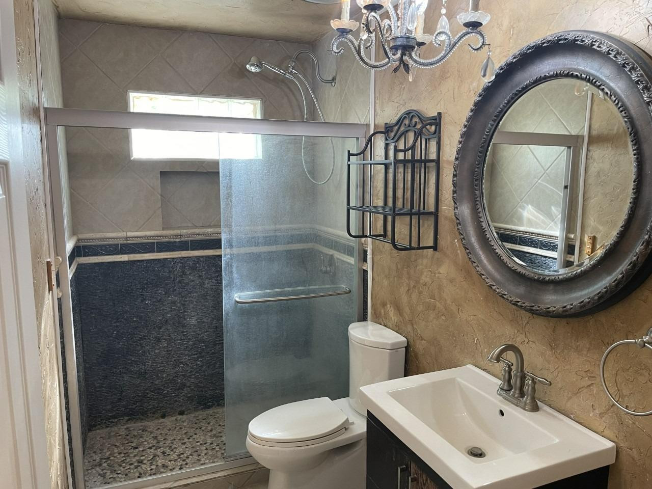 4832 9th Street Lubbock, TX 79416 - Photo 7 of 10 a bathroom with a toilet a sink and a mirror