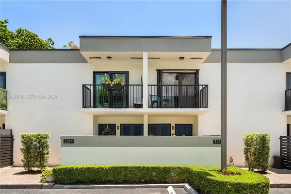 a backyard of a house with barbeque oven and outdoor seating