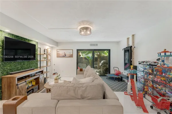 a living room with furniture and a flat screen tv
