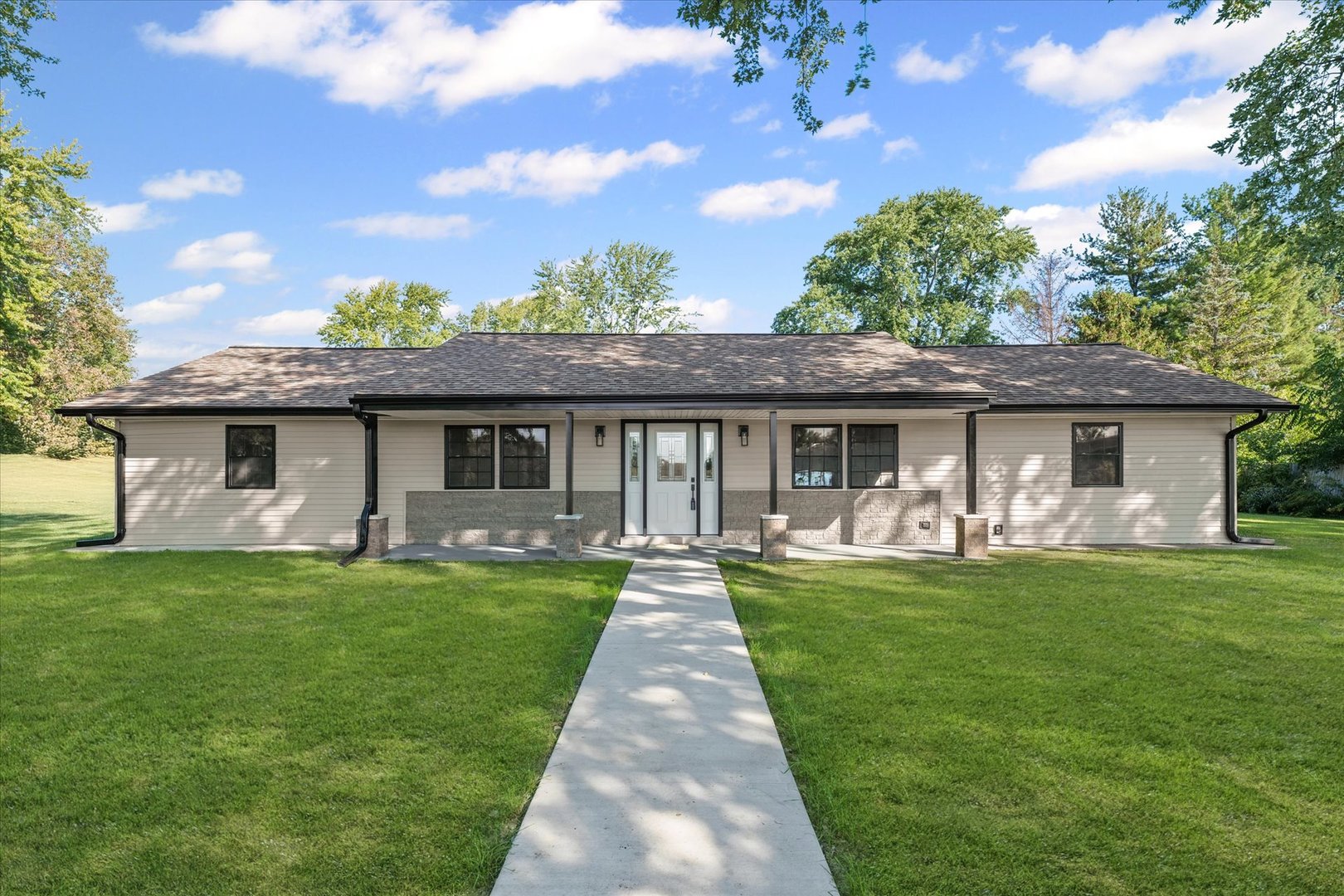 a front view of a house with a garden