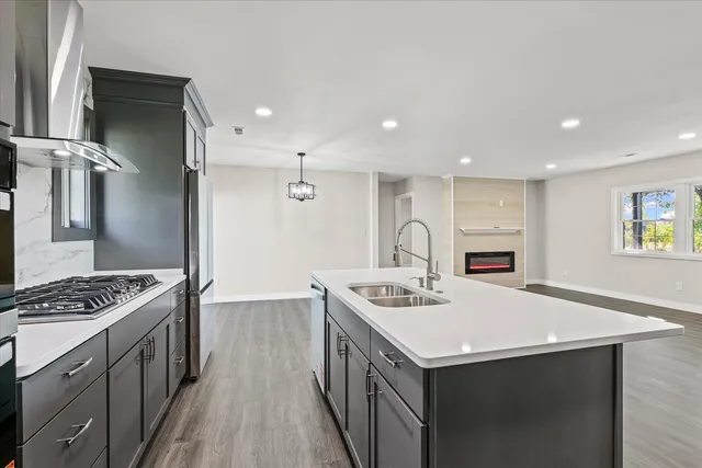 a kitchen that has a lot of cabinets a sink and a stove