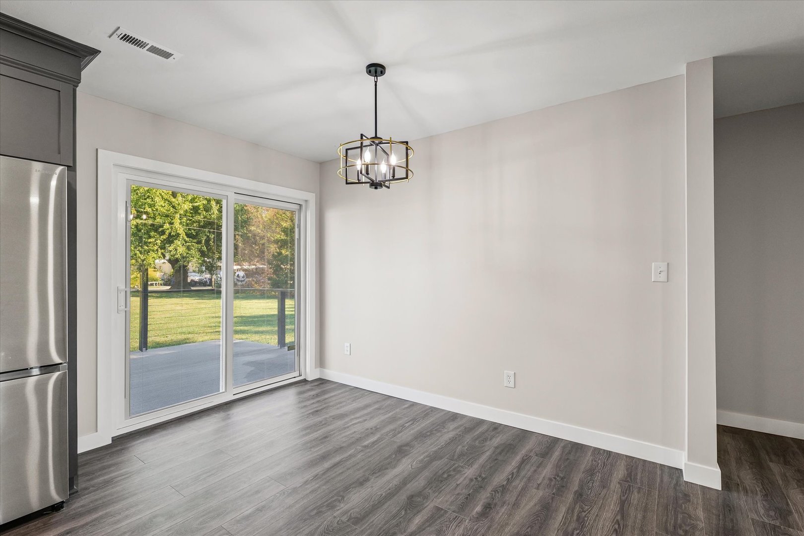 402 Beeson Road Urbana, IL 61802 - Photo 14 of 33 a view of empty room with wooden floor and fan