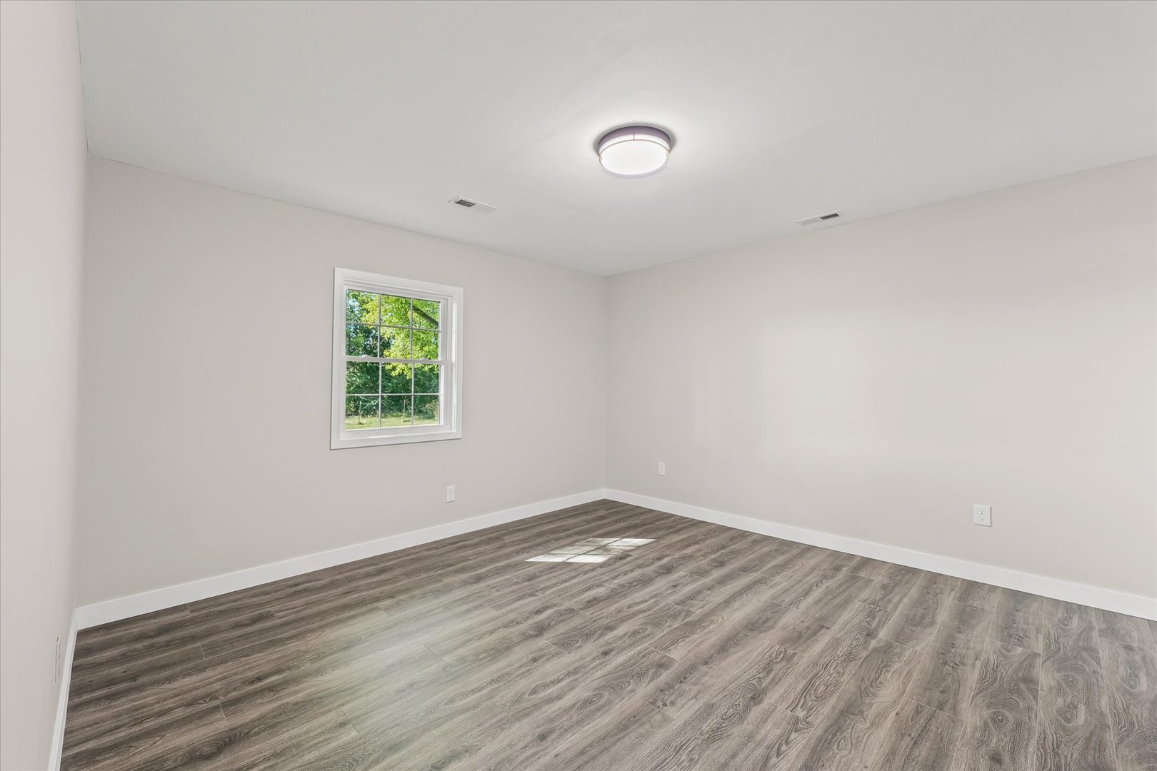 402 Beeson Road Urbana, IL 61802 - Photo 21 of 33 an empty room with wooden floor and windows