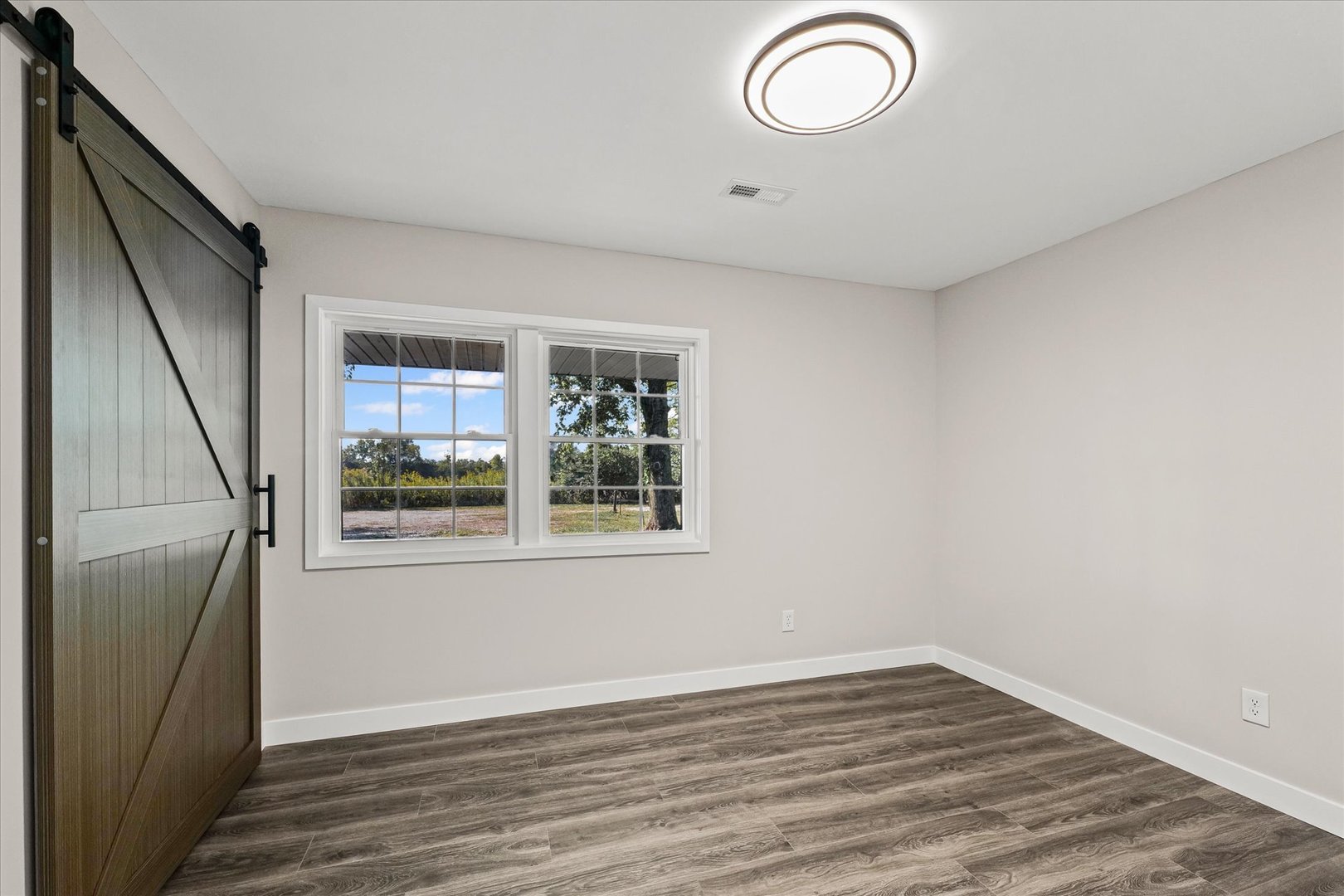 402 Beeson Road Urbana, IL 61802 - Photo 24 of 33 an empty room with wooden floor and windows