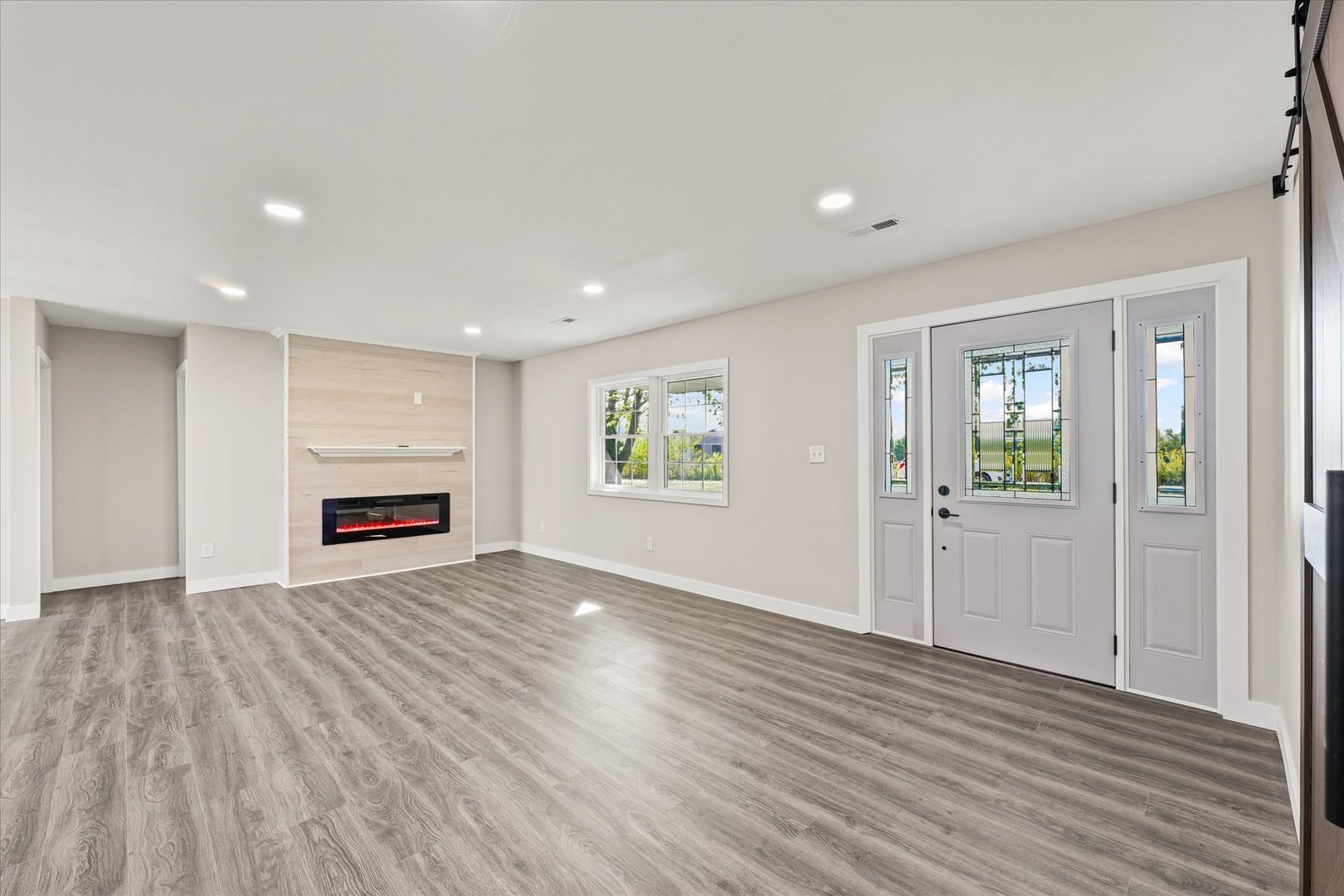 402 Beeson Road Urbana, IL 61802 - Photo 5 of 33 a view of an empty room with wooden floor and a window