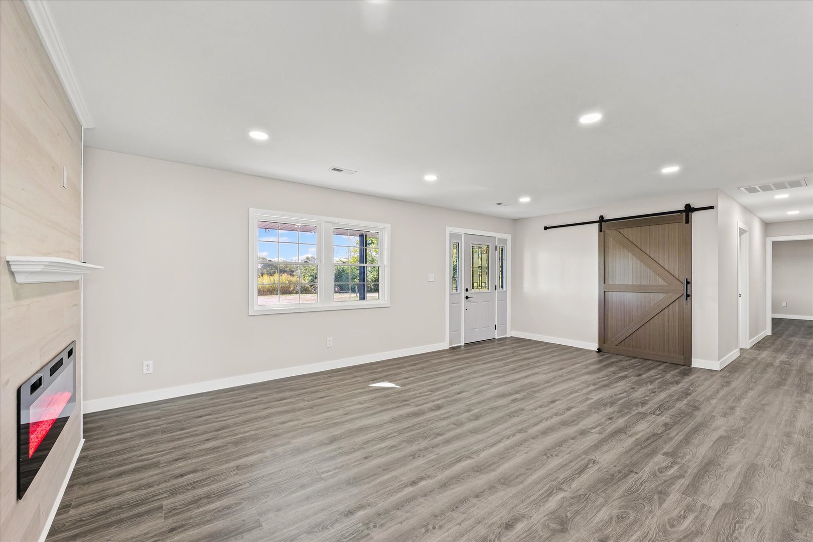 402 Beeson Road Urbana, IL 61802 - Photo 6 of 33 a view of an empty room with wooden floor and a window