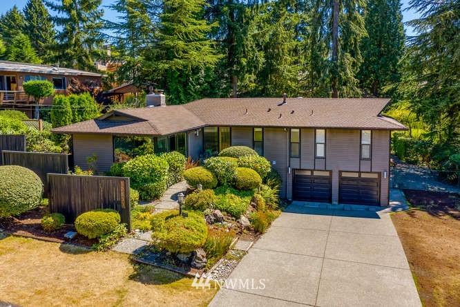 12833 Southeast 45th Place Bellevue, WA 98006 - Photo 1 of 40 a front view of a house with garden
