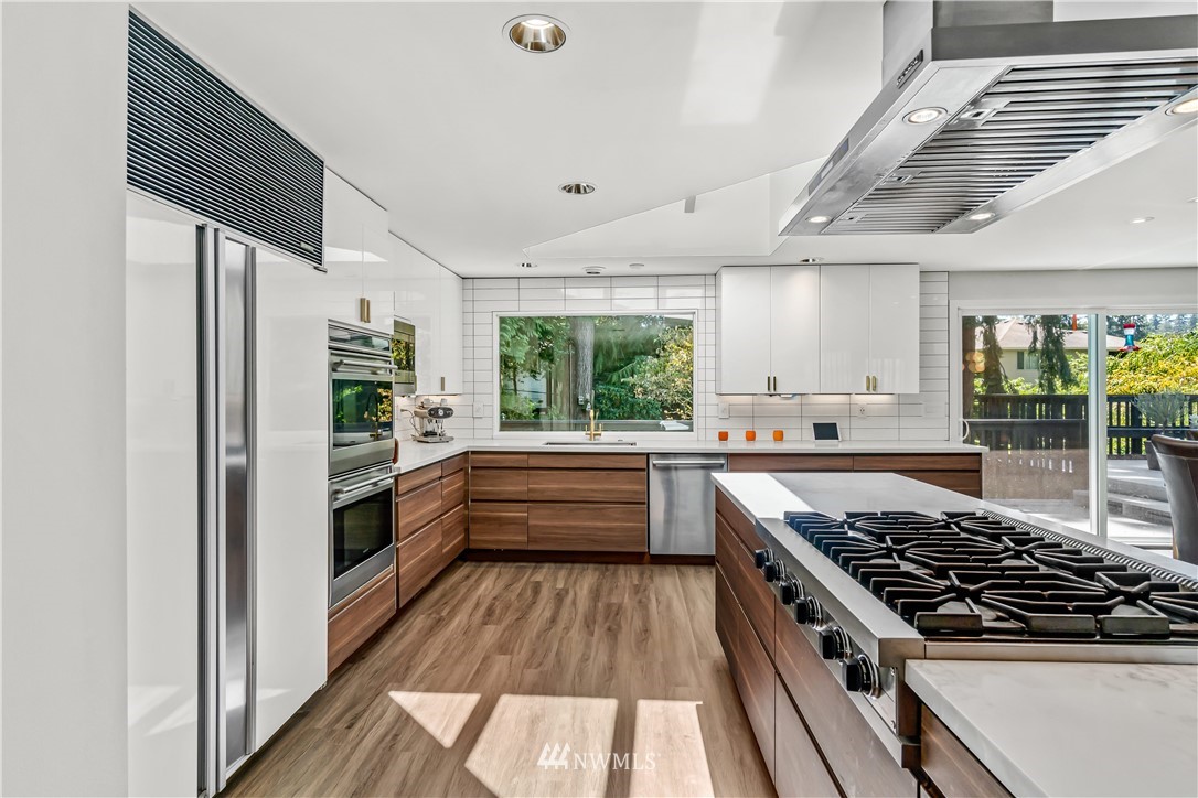 12833 Southeast 45th Place Bellevue, WA 98006 - Photo 11 of 40 a kitchen with stainless steel appliances a stove a sink and a refrigerator