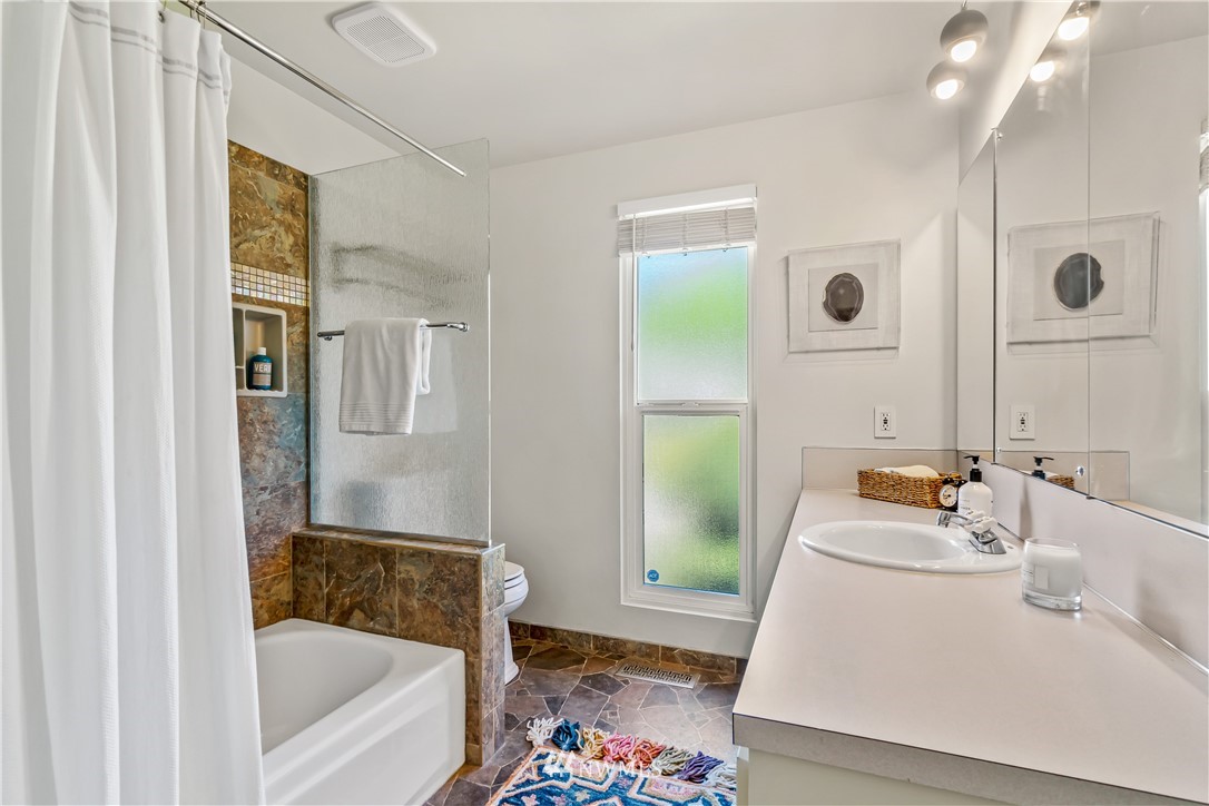 12833 Southeast 45th Place Bellevue, WA 98006 - Photo 21 of 40 a bathroom with a tub sink and mirror