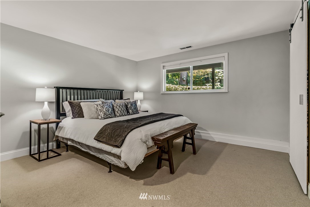12833 Southeast 45th Place Bellevue, WA 98006 - Photo 29 of 40 a bedroom with a bed lamp and a window