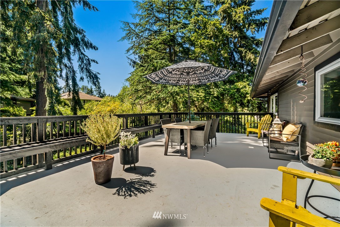 12833 Southeast 45th Place Bellevue, WA 98006 - Photo 34 of 40 a view of a swimming pool with a patio and wooden benches