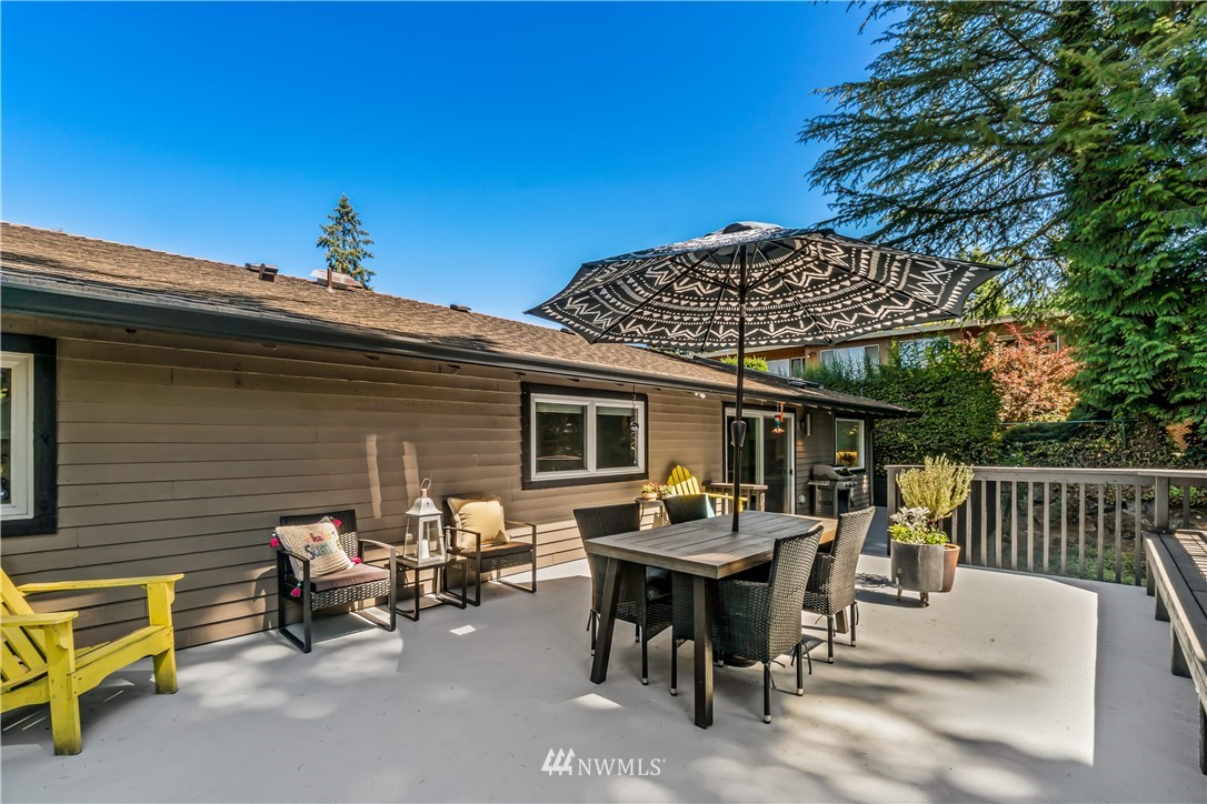 12833 Southeast 45th Place Bellevue, WA 98006 - Photo 36 of 40 a view of a patio with table and chairs with wooden floor and fence