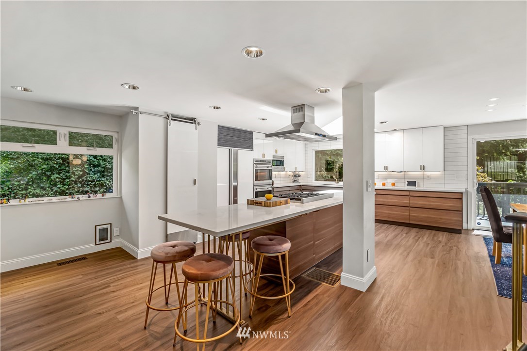 12833 Southeast 45th Place Bellevue, WA 98006 - Photo 9 of 40 a very nice looking room with kitchen view and a wooden floor