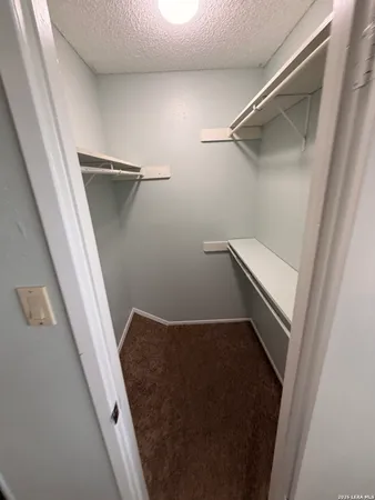 a view of empty room with a ceiling fan