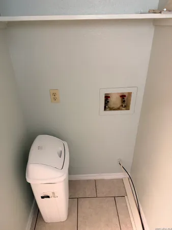 a kitchen with white cabinets a sink a stove and a refrigerator
