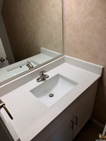 a bathroom with a sink and a white cabinet