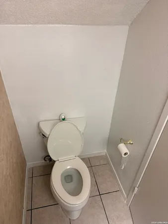 a bathroom with a toilet and a mirror