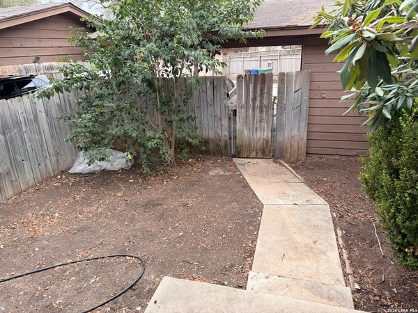a view of a brick house with potted plants