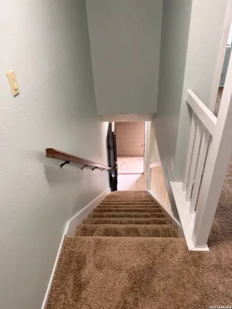 an empty room with a ceiling fan and a window