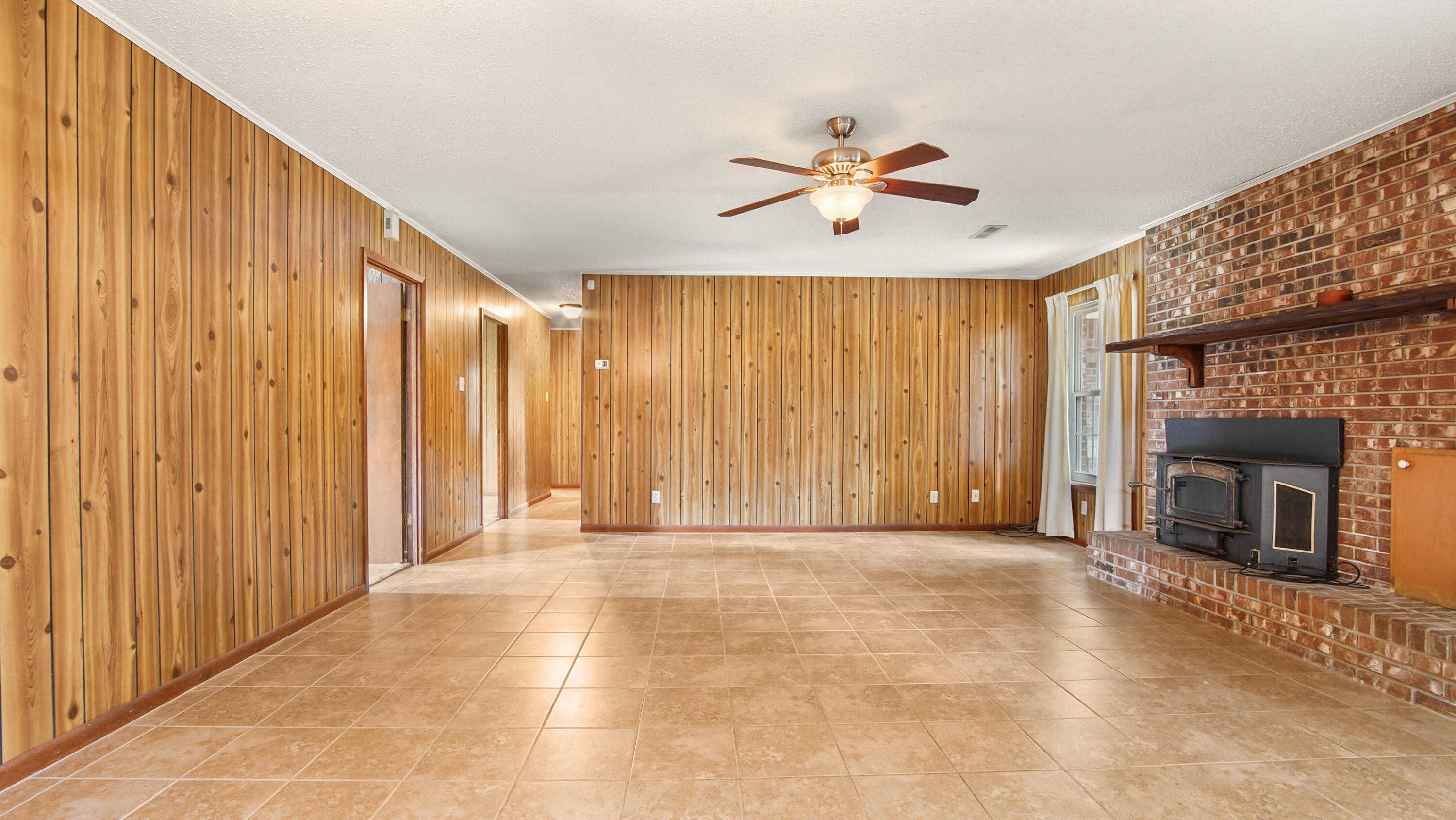 2374 Co Highway 280A DeFuniak Springs, FL 32435 - Photo 17 of 66 a view of an empty room with a fireplace and a window