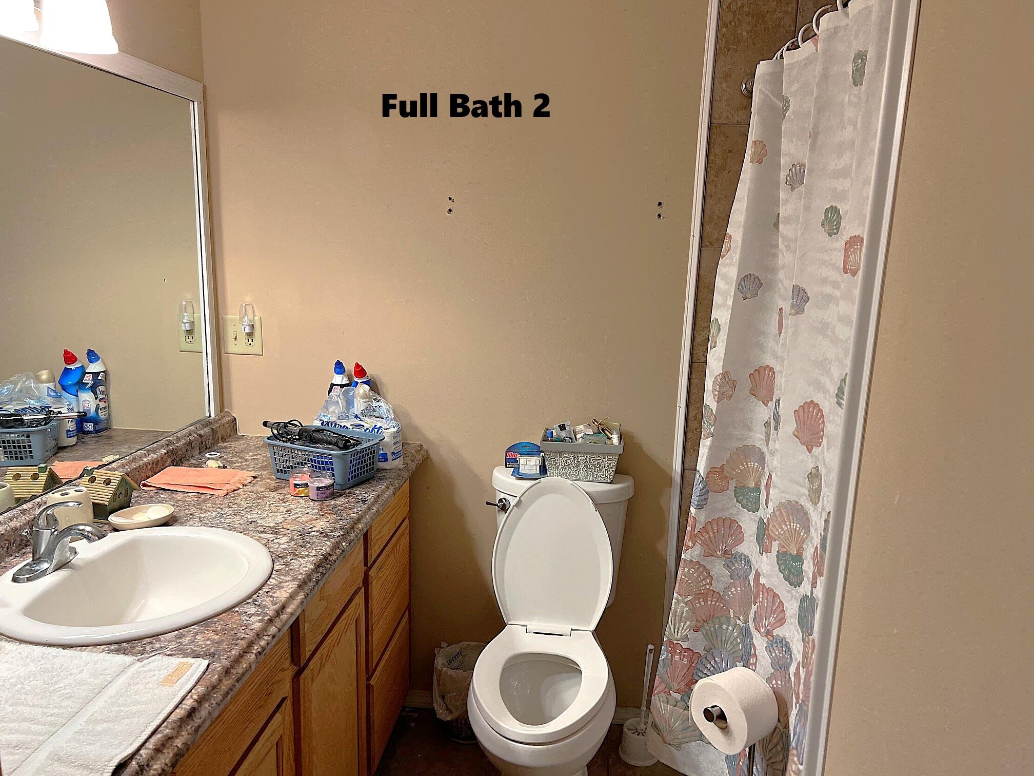 2374 Co Highway 280A DeFuniak Springs, FL 32435 - Photo 35 of 66 a bathroom with a granite countertop toilet sink and mirror