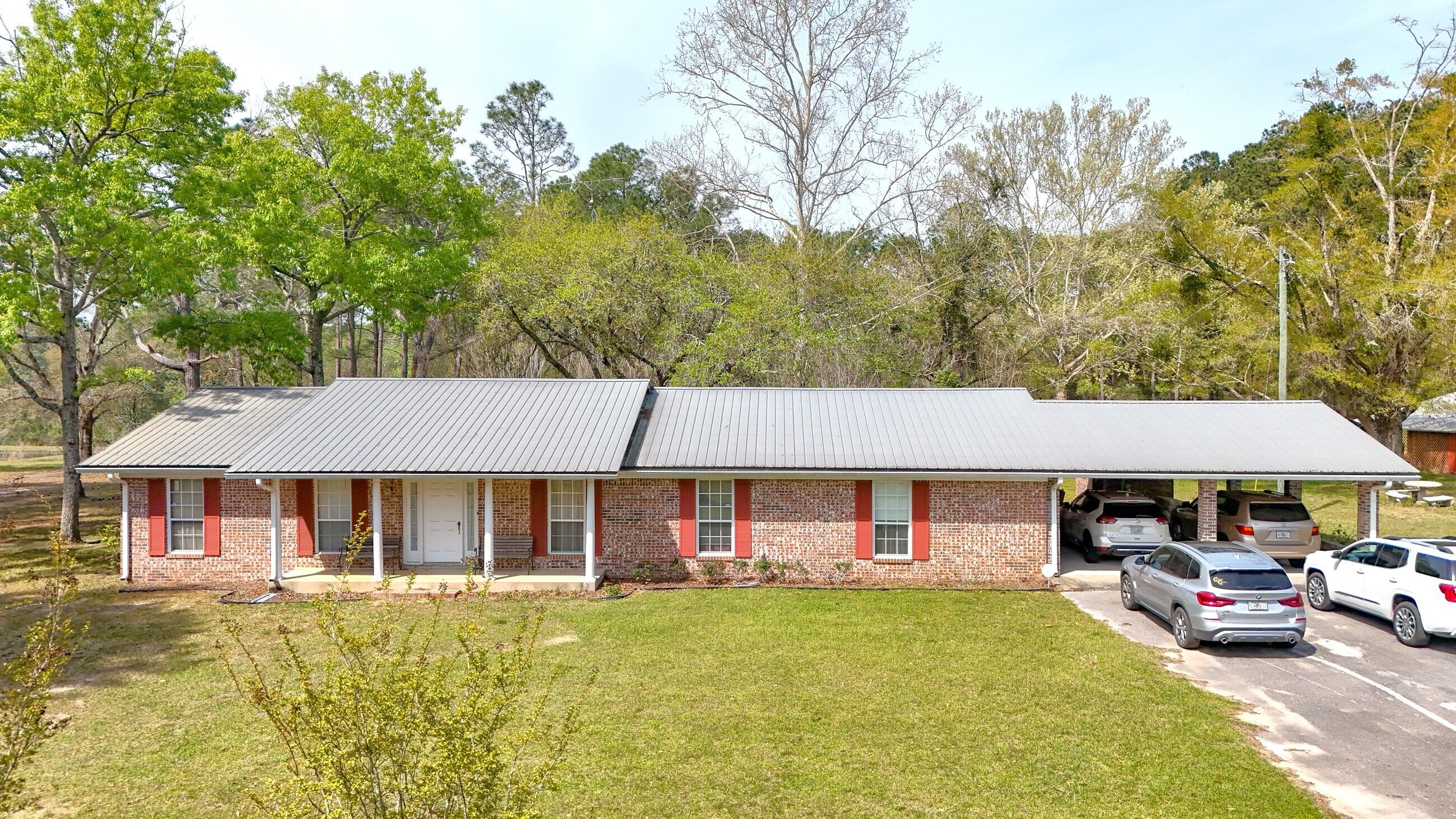 2374 Co Highway 280A DeFuniak Springs, FL 32435 - Photo 5 of 66 a view of house with garden and swimming pool