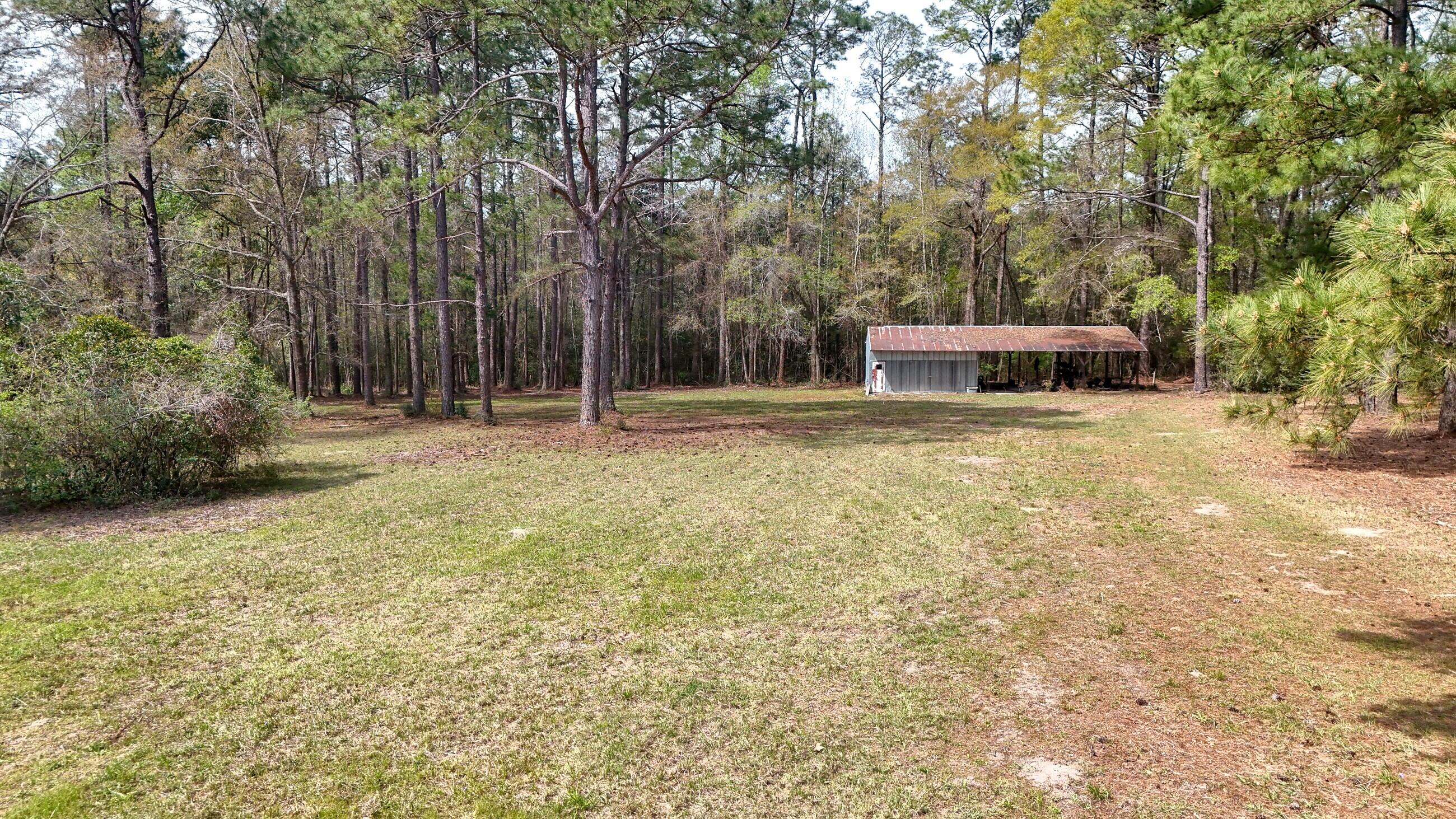 2374 Co Highway 280A DeFuniak Springs, FL 32435 - Photo 58 of 66 a backyard of a house with table and chairs