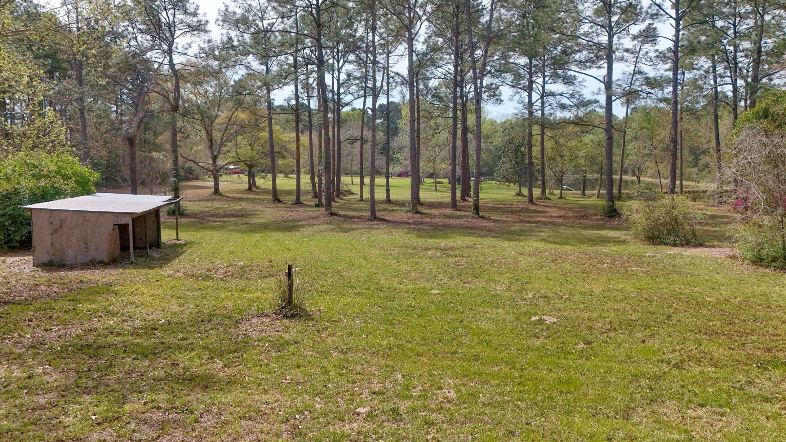 2374 Co Highway 280A DeFuniak Springs, FL 32435 - Photo 60 of 66 a backyard of a house with trees and outdoor seating