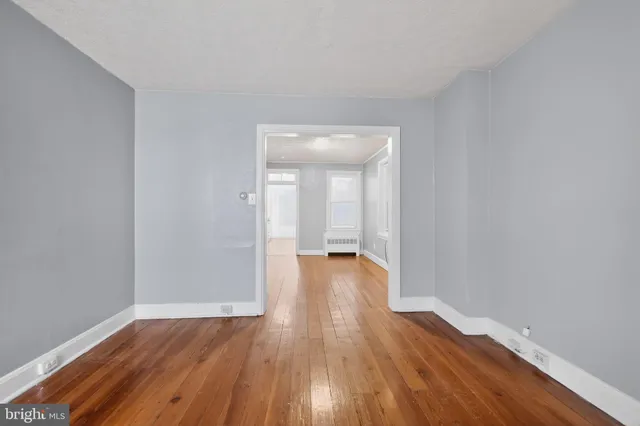 a view of a room with wooden floor