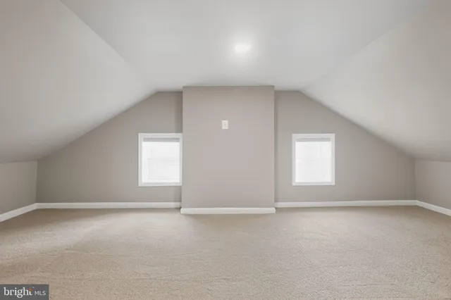 an empty room with a empty space and windows