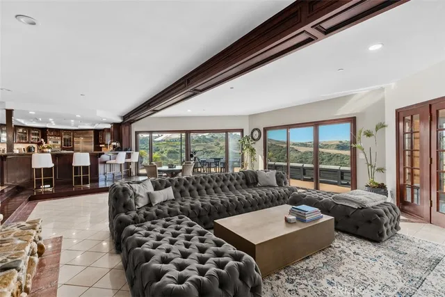 a living room with furniture large window and a table
