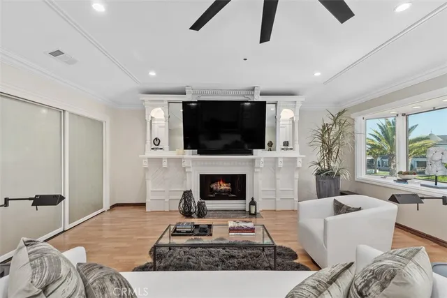 a living room with furniture a fireplace and a flat screen tv