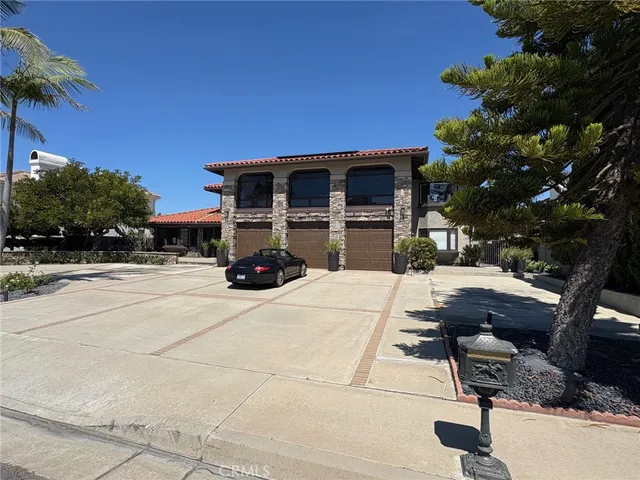a view of a patio with table and chairs with a barbeque grill and a small yard
