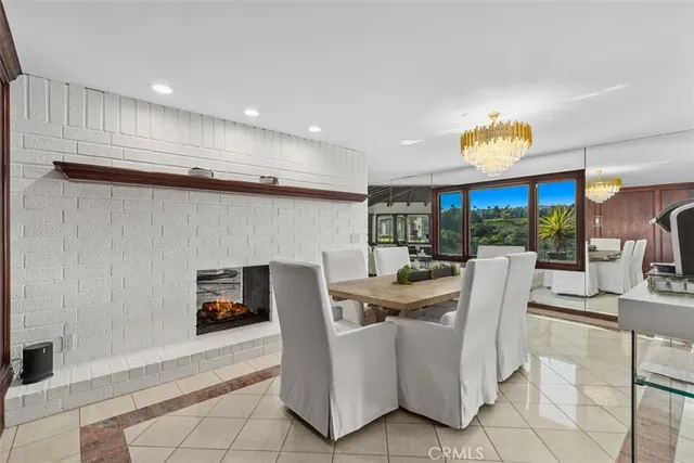a dining room with furniture and a floor to ceiling window