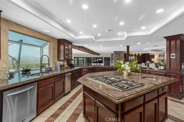 a kitchen with stainless steel appliances granite countertop a stove and a sink