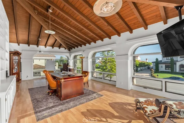 a living room with patio furniture and a floor to ceiling window