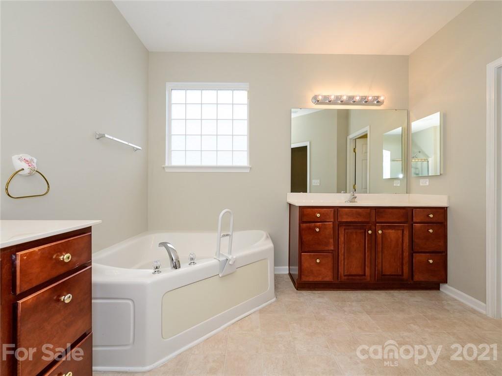 955 Platinum Drive Fort Mill, SC 29708 - Photo 27 of 37 a bathroom with a tub a double vanity sink and mirror