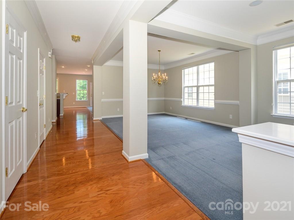 955 Platinum Drive Fort Mill, SC 29708 - Photo 4 of 37 a view of a hallway to an empty room with wooden floor and a window