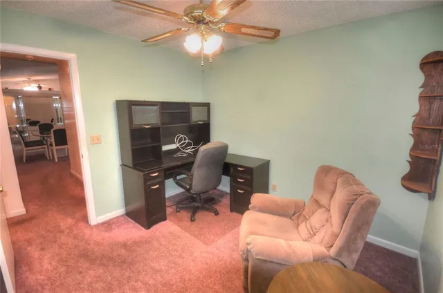 a workspace with furniture and a chandelier fan