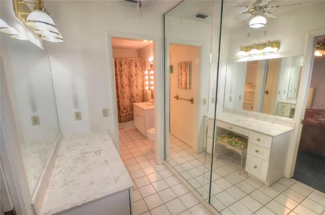a bathroom with a sink vanity and a mirror