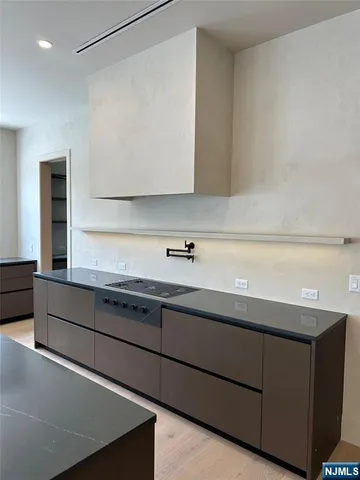 a kitchen with stainless steel appliances granite countertop a sink and a stove