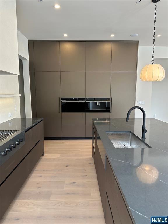 2 Maple Street Englewood Cliffs, NJ 07632 - Photo 12 of 44 a kitchen with stainless steel appliances granite countertop a sink and a stove