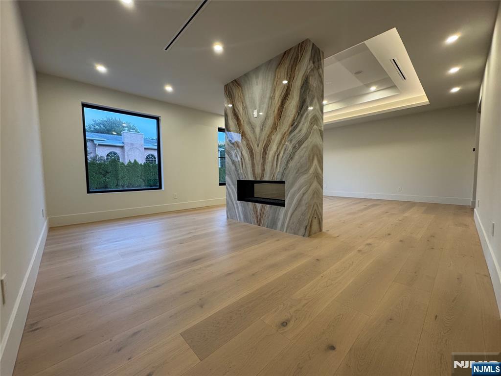 2 Maple Street Englewood Cliffs, NJ 07632 - Photo 17 of 44 an empty room with wooden floor and a ceiling fan