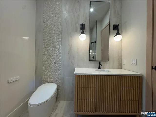 a kitchen with a sink a counter space and wooden floor
