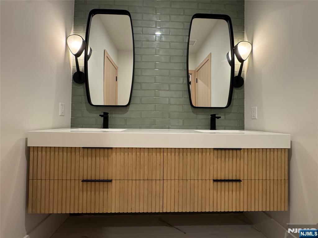 2 Maple Street Englewood Cliffs, NJ 07632 - Photo 33 of 44 a bathroom with a double vanity sink and a mirror