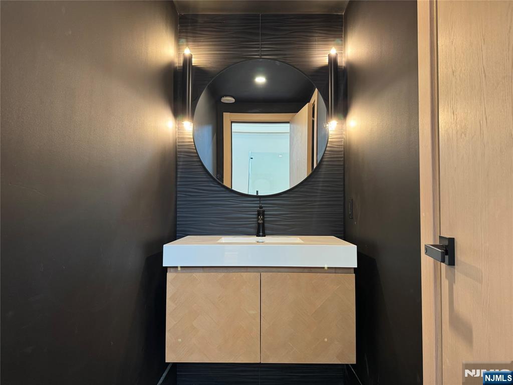 2 Maple Street Englewood Cliffs, NJ 07632 - Photo 39 of 44 a bathroom with a sink and a mirror