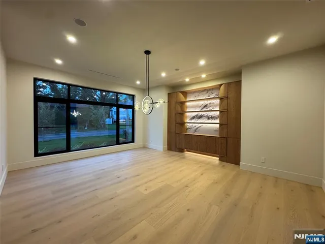 a open kitchen with stainless steel appliances granite countertop a large counter top and a refrigerator