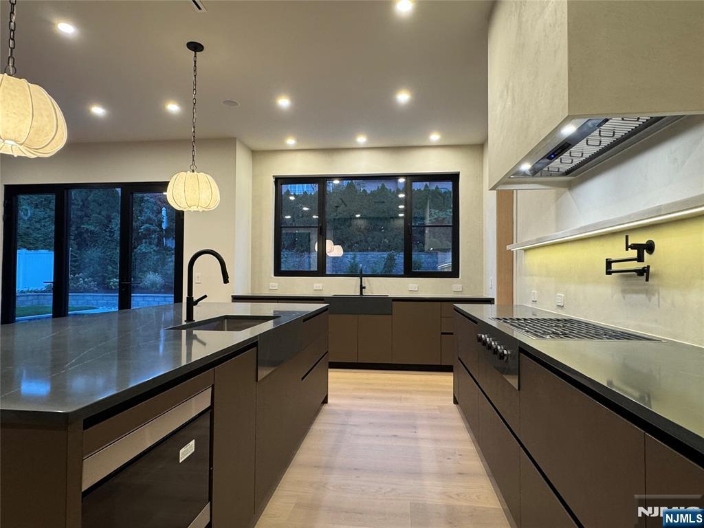 2 Maple Street Englewood Cliffs, NJ 07632 - Photo 10 of 44 a large kitchen with stainless steel appliances a large counter top a stove and a sink