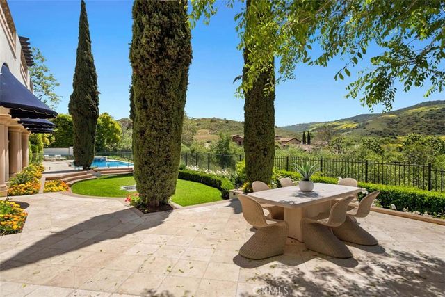 a view of a patio with couches table and chairs and potted plants